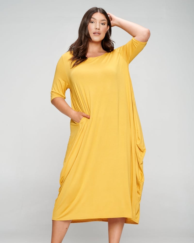 Front of a model wearing a size 1X Nevaeh Midi Dress in Mustard by L I V D. | dia_product_style_image_id:274191